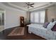 Inviting main bedroom featuring a tray ceiling, hardwood floors, and a bright window at 2871 Goldfinch Cir, Marietta, GA 30066