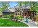 Secluded backyard oasis featuring a patio, lush greenery, and a covered porch at 4686 Buckskin Sw Trl, Lilburn, GA 30047
