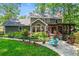 Green backyard with a lush lawn and landscaping, a beautiful home exterior and a patio with outdoor furniture at 4686 Buckskin Sw Trl, Lilburn, GA 30047