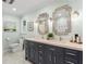 Updated bathroom featuring a double sink vanity, with decorative mirrors and hardware at 4686 Buckskin Sw Trl, Lilburn, GA 30047