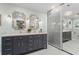 Bathroom features double sinks, a vanity, and a closet with mirrored doors at 4686 Buckskin Sw Trl, Lilburn, GA 30047