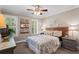 Bedroom features a ceiling fan, plush carpet and a window providing ample natural light at 4686 Buckskin Sw Trl, Lilburn, GA 30047