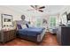 Spacious primary bedroom featuring hardwood floors, tray ceilings and an updated ceiling fan at 4686 Buckskin Sw Trl, Lilburn, GA 30047
