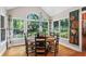Charming dining area with large windows overlooking the lush backyard at 4686 Buckskin Sw Trl, Lilburn, GA 30047