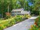 Well-maintained two-story home featuring a lush green lawn and long concrete driveway at 4686 Buckskin Sw Trl, Lilburn, GA 30047