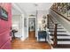 Welcoming foyer with hardwood floors, elegant staircase, and stylish decor at 4686 Buckskin Sw Trl, Lilburn, GA 30047