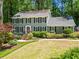 Charming two-story home with well-manicured landscaping and a lush green lawn at 4686 Buckskin Sw Trl, Lilburn, GA 30047