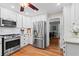 Modern kitchen featuring stainless steel appliances, white cabinets, and stylish finishes at 4686 Buckskin Sw Trl, Lilburn, GA 30047