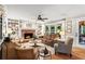 Inviting living room featuring a brick fireplace and built-in shelving and a plush leather sofa at 4686 Buckskin Sw Trl, Lilburn, GA 30047