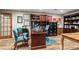 Home office features built-in bookshelves, a desk, hardwood floors, and a collection of memorabilia at 4686 Buckskin Sw Trl, Lilburn, GA 30047