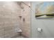 Walk-in shower featuring floor-to-ceiling marble tiles with built in shelves at 4686 Buckskin Sw Trl, Lilburn, GA 30047