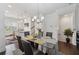 Open concept dining room with modern chandelier, hardwood floors and lots of natural light at 2161 Colvin Ct, Atlanta, GA 30318