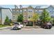 Exterior shot of a three-story townhome with a parking lot and partial green space at 2161 Colvin Ct, Atlanta, GA 30318