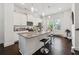 Bright kitchen featuring an island with bar seating, granite countertops, white cabinets, and stainless steel appliances at 2161 Colvin Ct, Atlanta, GA 30318