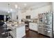 Bright kitchen featuring an island with bar seating, granite countertops, white cabinets, and stainless steel appliances at 2161 Colvin Ct, Atlanta, GA 30318
