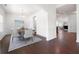 Dining area with modern table setting flows into a cozy living space featuring hardwood floors at 416 Blue Sky Cir, Acworth, GA 30102
