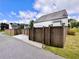 A fenced side yard with concrete driveway, green grass, and blue skies overhead at 416 Blue Sky Cir, Acworth, GA 30102