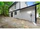 Backyard exterior featuring a two-story home with white siding and a small patio area at 534 Woodcrest Manor Dr, Stone Mountain, GA 30083