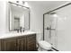 Modern bathroom featuring a sleek vanity, a black framed mirror, and a glass-enclosed shower at 534 Woodcrest Manor Dr, Stone Mountain, GA 30083
