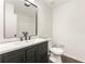 Bathroom features a vanity with dark wood cabinets, a sink, and a large framed mirror at 534 Woodcrest Manor Dr, Stone Mountain, GA 30083