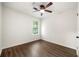 Bedroom with ceiling fan and a bright window, complemented by modern wood-look floors at 534 Woodcrest Manor Dr, Stone Mountain, GA 30083