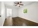Well-lit bedroom with a ceiling fan, wood-look floors, and a bright window at 534 Woodcrest Manor Dr, Stone Mountain, GA 30083