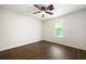 Bedroom features wood-look flooring, bright window, and a ceiling fan with lighting at 534 Woodcrest Manor Dr, Stone Mountain, GA 30083