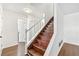 Bright foyer featuring hardwood stairs, white walls and trim at 534 Woodcrest Manor Dr, Stone Mountain, GA 30083