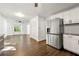 Kitchen featuring white cabinetry, stainless steel refrigerator, and dark hardwood floors at 534 Woodcrest Manor Dr, Stone Mountain, GA 30083
