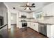 Updated kitchen with stainless steel appliances, white cabinetry, and dark hardwood floors at 534 Woodcrest Manor Dr, Stone Mountain, GA 30083