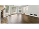 Spacious living room featuring dark hardwood flooring, fireplace, and large windows at 534 Woodcrest Manor Dr, Stone Mountain, GA 30083