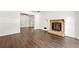 Open-concept living room featuring dark hardwood flooring and stone fireplace at 534 Woodcrest Manor Dr, Stone Mountain, GA 30083