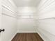 Walk-in closet provides ample storage with built-in shelving and wood-look flooring at 534 Woodcrest Manor Dr, Stone Mountain, GA 30083