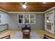 Covered back porch with wood ceiling and a seating area with scenic backyard views at 331 Terrell Sw Dr, Marietta, GA 30064