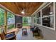 Inviting back porch with wood ceiling, fan, and comfortable seating area at 331 Terrell Sw Dr, Marietta, GA 30064