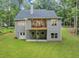Backyard view of gray home with large deck, walkout basement, and manicured lawn at 331 Terrell Sw Dr, Marietta, GA 30064