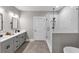Bright bathroom with double sinks, framed mirrors and a glass enclosed shower with marble tile at 331 Terrell Sw Dr, Marietta, GA 30064