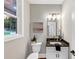 Charming half bathroom featuring a granite countertop and natural light from the window at 331 Terrell Sw Dr, Marietta, GA 30064