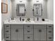 Bathroom featuring a modern double vanity, framed mirrors, and designer lighting at 331 Terrell Sw Dr, Marietta, GA 30064