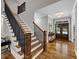 Bright foyer with hardwood floors, staircase with wood and black banister, and double doors creating an inviting entrance at 331 Terrell Sw Dr, Marietta, GA 30064