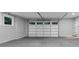 Bright garage with concrete floors, white walls, and garage door with windows at 331 Terrell Sw Dr, Marietta, GA 30064