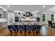 Modern kitchen with a large island, blue chairs, and stainless steel appliances at 331 Terrell Sw Dr, Marietta, GA 30064