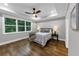 Spacious main bedroom boasting tray ceilings, hardwood floors, and a large window overlooking a wooded area at 331 Terrell Sw Dr, Marietta, GA 30064