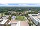 Wide aerial view of commercial district with a football field, educational campus, buildings and skyscrapers in the distance at 3388 Elgin Dr, Decatur, GA 30032