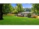 Spacious backyard with a well-maintained lawn, privacy fence, and a patio for outdoor entertaining at 3388 Elgin Dr, Decatur, GA 30032