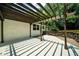 Backyard patio features a pergola, a wooden fence, a brick wall, and a concrete floor at 3388 Elgin Dr, Decatur, GA 30032