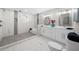 Modern bathroom with marble tile, a double sink vanity, and walk-in shower at 3388 Elgin Dr, Decatur, GA 30032