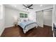 Bedroom featuring a sliding barn door, ceiling fan, and a large window that fills the space with natural light at 3388 Elgin Dr, Decatur, GA 30032