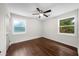 Bright bedroom featuring hardwood flooring, two large windows, and a ceiling fan at 3388 Elgin Dr, Decatur, GA 30032