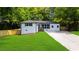 Charming home with a well-manicured lawn, freshly painted white brick and modern black trimmed windows at 3388 Elgin Dr, Decatur, GA 30032